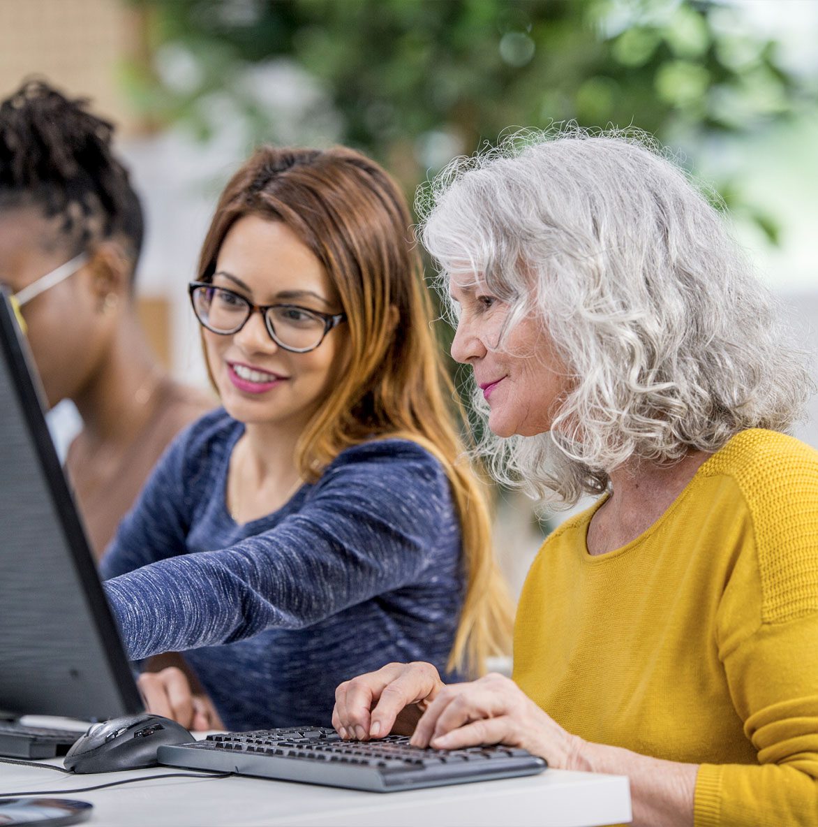 two people working together on a computer