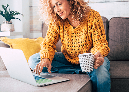 Woman working from home with mug of tea